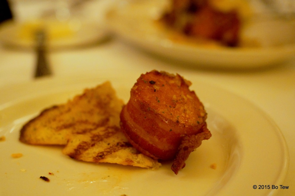 Bacon-wrapped scallop with Texas Garlic Toast.