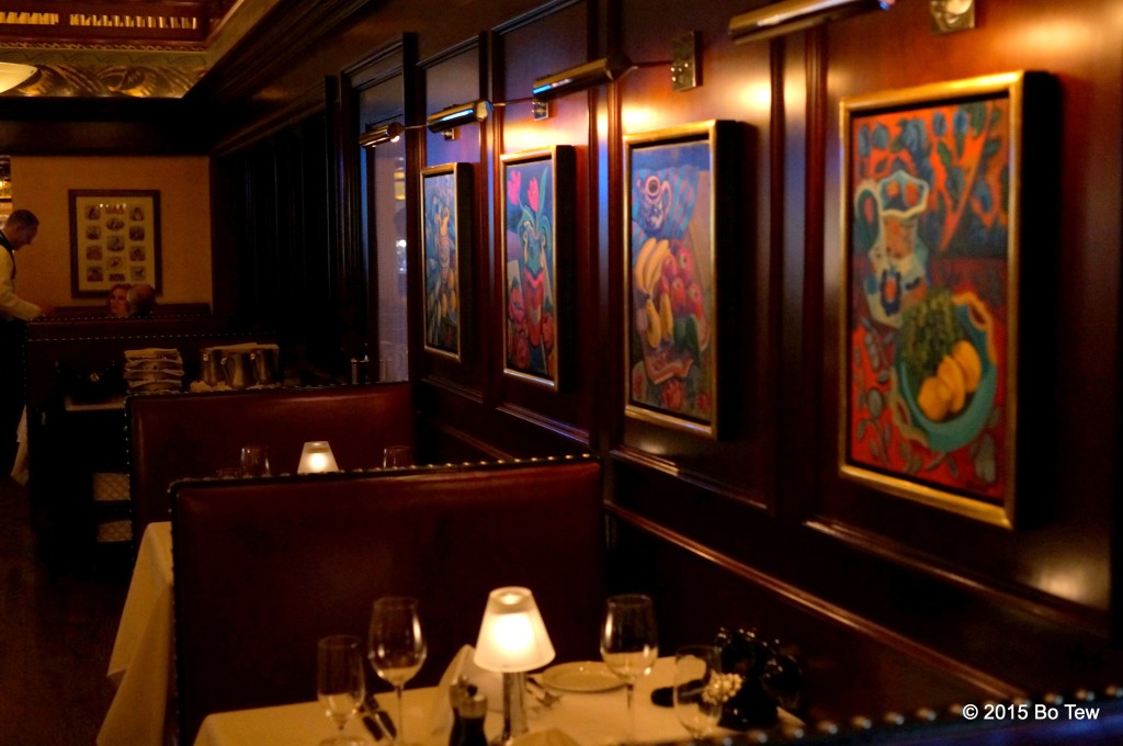 Food paintings alongside cozy booths.